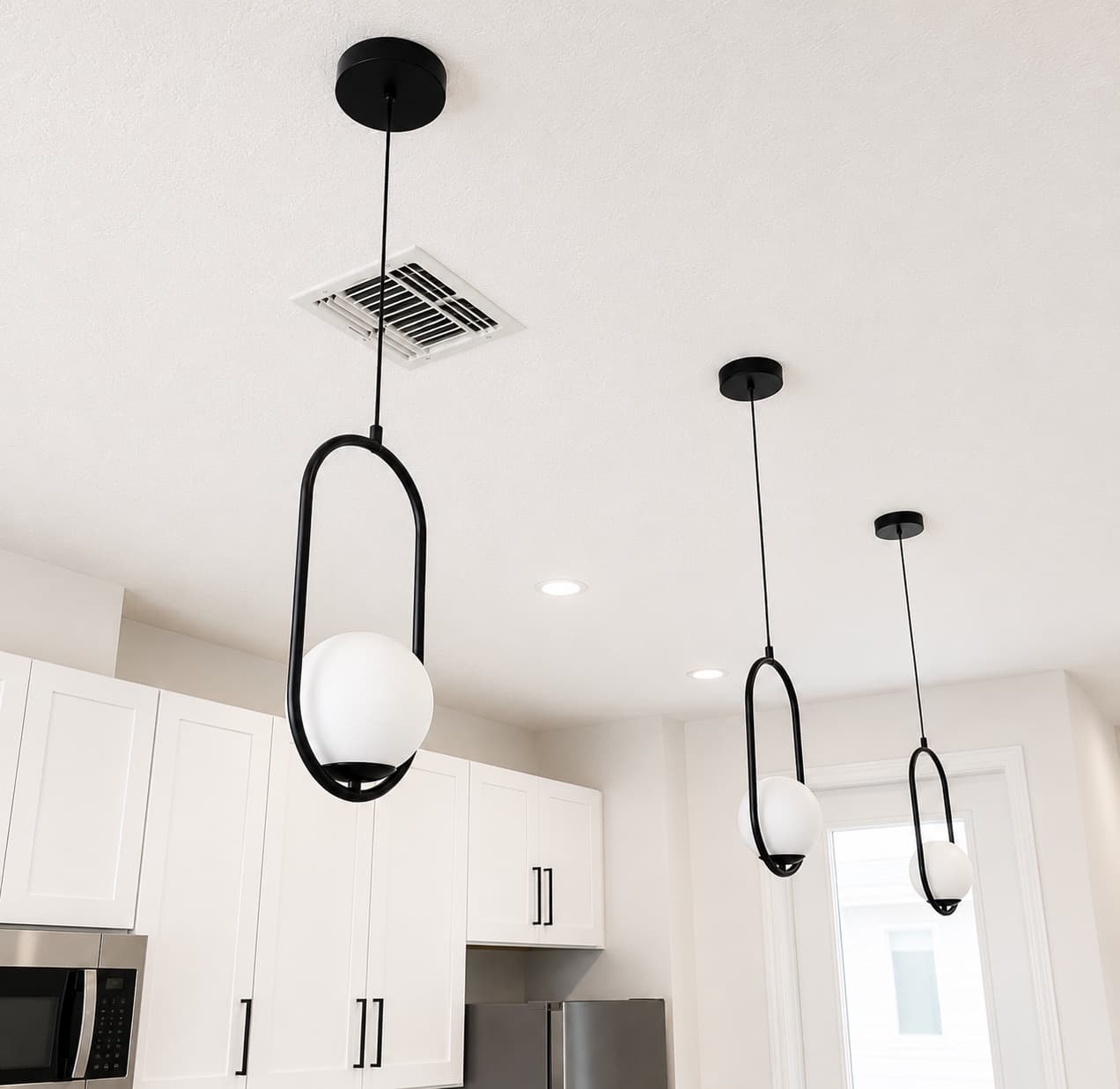 Kitchen pendant lights and recessed downlights installed in a Central Florida home